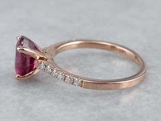 "This engagement ring combines beautiful rich pink rose gold and a deep pink Ceylon sapphire. The glittery deep pink sapphire center sits low in the mounting, and really brings out the pink hue of the wide polished rose gold band. Studded with high-quality bright diamonds, this ring is classic and timeless, and its high profile makes it super easy to wear with a variety of bands. Metal: 14K Rose Gold Gem: Pink Sapphire 2.18 Carats Gem Measurements: 8.3 x 6.2 mm, Oval Accents: 12 Diamonds totalin Rose Gold Ruby Jewelry With Brilliant Cut, Rose Gold Ruby Ring With Ethical Diamonds, Rose Gold Ruby Wedding Ring With Prong Setting, 14k Rose Gold Ruby Ring With Prong Setting, Pink Ruby Ring In 14k Rose Gold, Wedding Pink Ruby Ring In 14k Rose Gold, Pink Ruby Ring In 14k Rose Gold For Wedding, Fine Jewelry Rose Gold Ruby Ring With Brilliant Cut, Rose Gold Ruby Ring With Accent Stones Fine Jewelry