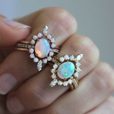 Our signature design is recreated with a stunning Australian opal and diamonds making it the dreamiest of all ring sets and goes by the name of Serena. Perfect engagement or wedding ring set for lovers of special rings.
 The price is for the complete ring set (all three rings).
Details
Solitaire ring


Main stone: Australian oval opal


Measurements: approx. 9x7 mm


Band stones: white diamonds


Quality: color grade G, clarity grade VS, conflict-free


Diamonds measurements: approx. 1.25 mm (12 Pastel Ring, Oval Opal Ring, Unique Bridal Jewelry, Australian Opal Ring, Diamond Bridal Ring Sets, Fine Gold Jewelry, Rainbow Opal, Opal Engagement, Three Rings