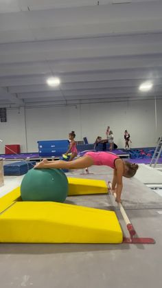 some people are doing gymnastics in an indoor gym