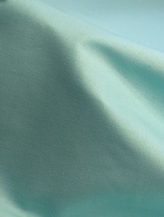 a close up view of a light blue fabric