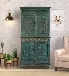 a green cabinet sitting in the corner of a room next to a chair and potted plant