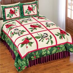 a christmas themed bed spread with cardinals and holly