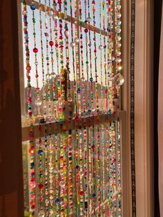 a window with beads hanging from it's side