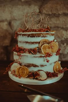 a wedding cake decorated with lemons and berries