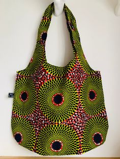 This fabric shopper is made out of a classic African print in a beautiful red and line green colour way.  I make each pattern of Polly Bags in small quantities and the inspiration is always the design of the fabric used. I have been making and selling these bags for several years now and the feed back from owners is that they are very strong, versatile and they last!   Buyers come back for more for themselves or they buy them as gifts for others.   The bag is unlined and measures 20 inches (51cm Green Reversible Bag For Daily Use, Reusable Green Shoulder Bag For Everyday, Everyday Reusable Green Shoulder Bag, Red Reusable Everyday Bag, Green Reusable Bags For Gift, Green Reversible Tote Bag, Red Reusable Bag For Daily Use, Green Reusable Shopping Bags, Eco-friendly Handmade Red Bag