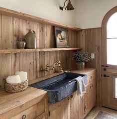 a kitchen with wood paneling and an antique sink