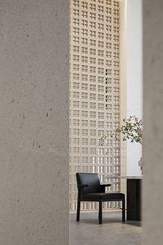 a black chair sitting next to a tall building