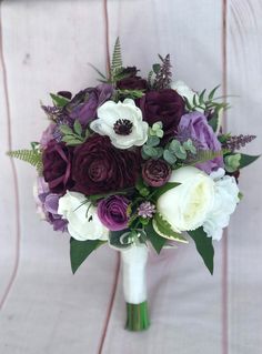 a bridal bouquet with purple and white flowers