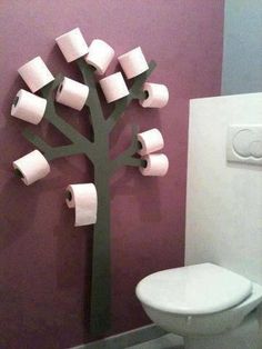 a bathroom with toilet paper rolls on the tree