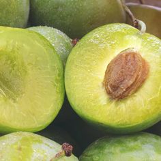 a pile of green fruit sitting on top of each other