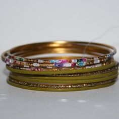 This Is A Beautiful Bangle Set. It Still Has The Plastic Tag Holding The Set Together. The Bangles Equal 1 Inch Tall And They Are 2.5 Inches Wide Across. Add At Least Five Items In Your Bundle And Receive A Special Offer 50% Off Original Bundle Price! Buy From Me With Confidence! I Have Sold Over 9000 Items With A 5 Star Rating! I Ship Quickly! Just Comment In The Bundle Saying You Are Done Green Metal Bracelets For Festive Occasions, Yellow Metal Bangle Bracelet, Multicolor Stackable Metal Bracelets, Yellow Metal Bracelets For Party, Clock Necklace, Rose Gold Bangle Bracelet, Colorful Bangles, Over 9000, Green Charms