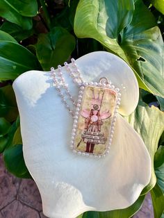 a close up of a necklace on a flower