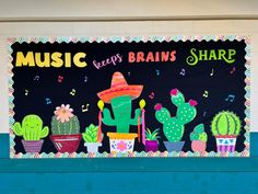 a colorful bulletin board with cactuses and music notes on it's front wall