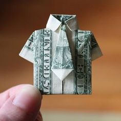 a folded dollar bill in the shape of a man's shirt and bow tie