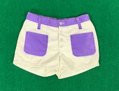 "B E S T  F I T S  Suggested Size: 0/2  Please check measurements below to ensure the best possible fit.    D  E  S  C  R I  P  T  I  O  N    *Beige and purple denim short shorts  *Button up front  *Two front pockets  *Belt loops  *3\" Inseam  *There is no stretch to the item  *1970s  era    D  E  T  A  I  L  S    * Fabric:  No label - cotton denim  * Care: Machine wash  * Marked Size: 7  * Maker's Label: Sears Jr. Bazaar     M  E  A  S  U  R  E  M  E  N  T  S    (Measurements are taken flat acr Purple Denim, Denim Short Shorts, Time Travelers, Pocket Belt, No Label, Cool Jackets, Denim Short, Short Shorts, The Purple