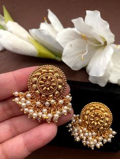 Shine like a glowing star in these high quality Kundan party wear studs lined with fine pearls .Pair them up with your silks and satins and add charm and charisma to your beautiful personality. Height = 30 mm || Width = 35 mm Latest Design Antique Earring Gorgeous studs with pearls. Highest quality and craftsmanship Ready to ship from NJ USA Please contact us for any questions Heavy Pearl Earrings For Festivals Gift, Heavy Pearl Earrings For Festivals, Temple Style Dangle Pearl Earrings For Festivals, Temple Jewelry Pearl Dangle Earrings For Festivals, Temple Jewelry Dangle Pearl Earrings For Festivals, White Earrings For Puja And Festivals, Temple Jewelry Pearl Earrings With Latkans For Gifts, Fusion Gold Pearl Earrings For Festivals, Gold Fusion Pearl Earrings For Festivals