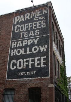 an old sign on the side of a building that says farmers coffee teas happy hollow coffee