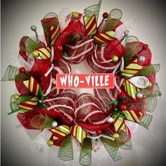 a wreath with red, green and white ribbons that says who - vulle on it