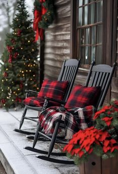 two rocking chairs with plaid blankets on them are sitting in front of a christmas tree