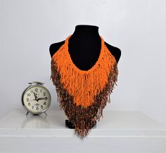 Unique African Maasai Handcrafted Beaded Necklace with an Elegant Look and Brilliant Finish. Circumference = 16 Inches/ 41 Centimeters. Color =Orange and Multi-Color Maasai Beads. Fringe = 10 Inches / 26 Centimeters. **GET FREE SHIPPING FOR ADDITIONAL ITEMS PURCHASED. Yes, Buy Multiple Items and pay shipping for 1 item only- The rest ships Free. (No Limits on the number of Multiple items). With a faster delivery time of 3 days via DHLExpress, Worldwide. Ordinary/Standard Shipping also available Woman Necklace, Handmade Beaded Necklace, Ethnic Necklaces, Handmade Beaded Necklaces, Maasai, African Jewelry, Zulu, African Women, Kenya