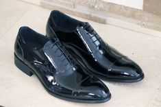 Style: 505-101P-Black Exclusively for C & E Shoes, this Elegant Patent Leather lace-up Oxford from the Carrucci collection features a cap-toe and a clean welt! Black Lace-up Oxfords With Rubber Heel Cap, Black Cap Toe Lace-up Shoes For Office, Black Cap Toe Oxfords With Rubber Heel Cap, Fitted Black Lace-up Shoes For Derby, Formal Black Lace-up Shoes With Rubber Heel Cap, Black Patent Leather Cap Toe Lace-up Shoes, Classic Black Oxfords With Laces, Luxury Black Fitted Lace-up Shoes, Luxury Fitted Black Lace-up Shoes