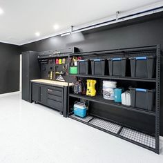 a garage with black shelving and lots of storage