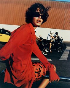 a woman sitting on the back of a motorcycle