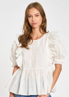 The Eyelet Puff Sleeve Top with its peplum hem and cascading ruffle detail to offset subtle princess sleeves, also features eyelet lace insets, creating a beautiful boho effect. This blouse is the quintessential springtime silhouette, and pairs well with your favorite jeans! Chic Cotton Blouse With Cutwork Hem, Elegant Tops With Cutwork Hem For Spring, Chic Fitted Blouse With Cutwork Hem, Elegant Spring Top With Cutwork Hem, Spring Puff Sleeve Top With Ruffle Hem, Feminine Broderie Anglaise Blouse For Brunch, Feminine Puff Sleeve Top With Ruffled Collar, Peasant Puff Sleeve Top For Spring, Spring Peasant Puff Sleeve Top