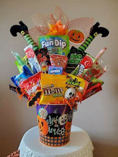 a basket filled with candy and candies on top of a cake