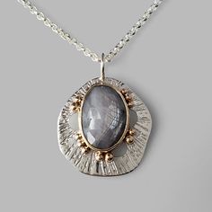 grey sapphire set in yellow gold on textured silver pendant with gold dots Silver Handmade Necklace, Copper And Silver Jewelry, Handmade Jewelry Silver, Handmade Silver Necklace, Silversmith Pendant, Silver Clay Jewelry Ideas, Handmade Chain Jewelry, Metal Clay Art, Art Jewelry Necklace