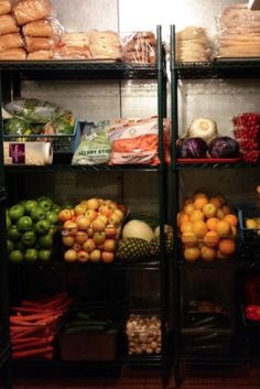 shelves filled with fruits and vegetables in a grocery store