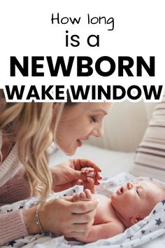 a woman holding a baby in her lap with the caption how long is a newborn wake window?