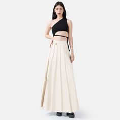 Step into effortless elegance with the Solace Vegan Leather Pleated Maxi Skirt in white. With a hidden zip closure and stylish golden embellishments, this skirt combines sophistication with a touch of luxury. The lightweight fabric drapes beautifully, offering a relaxed yet structured fit with just the right amount of stretch for comfort and durability. The vertical hand-pleating creates a flattering silhouette by elongating the lower body. Perfect for stylish occasions where comfort is key, thi Luxury Pleated Skirt For Spring, Luxury White Skirt For Spring, Elegant White Pleated Evening Skirt, Elegant Beige Pleated Skirt For Party, Elegant Beige Pleated Party Skirt, Elegant Beige Asymmetrical Maxi Skirt, White Fitted Pleated Skirt For Evening, Fitted White Pleated Skirt For Evening, Luxury Lined Skirt For Spring