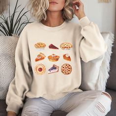 This cute Fall Vibes Thanksgiving Sweatshirt is the perfect cozy addition to your wardrobe for the autumn season. Whether you're celebrating Thanksgiving with family or friendsgiving with your loved ones, this sweatshirt exudes warm vibes and comfort. It is ideal for anyone looking for a stylish and festive outfit for the fall holidays. HOW TO ORDER - Select your desired size, color, and design from the dropdown menus. - Add each t-shirt to your cart separately. - Once you've selected all your i Sweet White Tops For Fall, Cute Fall T-shirt, Cute Cozy Fit Tops For Fall, Sweet Fall Crew Neck Top, Sweet Crew Neck Top For Fall, Cottagecore Thanksgiving, Thanksgiving With Family, Thanksgiving Sweatshirt, Girls Thanksgiving