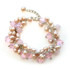 Show off your girly side with our Pink Rose Quartz Cluster Bracelet. This bracelet is made out of clusters of pink synthetic pearls along with touches of pink crystal for a sparkle effect. It is finished off with bits of rose quartz throughout the bracelet. Consider pairing with our Pink Petal Shimmer Necklace for the complete look. The bracelet is 7 inches long with a 2 inch extendable chain. Elegant Pink Crystal And Pearl Bracelet, Elegant Pink Pearl Crystal Bracelet, Pink Pearl Bracelet For Party, Pink Pearl Party Bracelet, Party Pink Pearl Bracelet, Pink Pearl Charm Bracelet, Pink Pearl Beaded Bracelets For Parties, Feminine Pink Pearl Bracelets, Cluster Bracelet