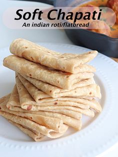 a stack of pita bread sitting on top of a white plate