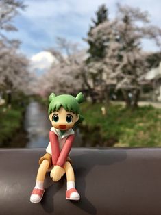 a small toy sitting on top of a rail