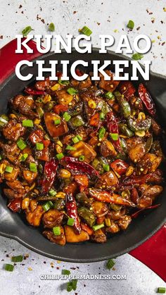 a pan filled with chicken and vegetables on top of a table