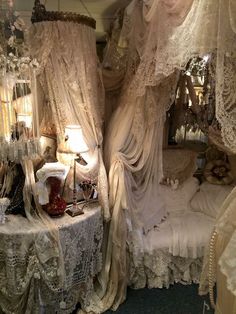 there is a bed covered in white lace