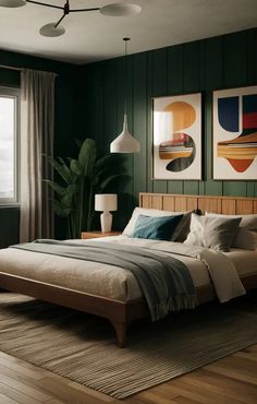 a bedroom with green walls and wooden floors, two paintings on the wall above the bed