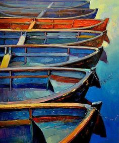 there are many small boats that are in the water, and one is painted with acrylic paint