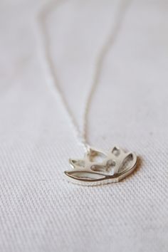 An original Lola&Cash protea necklace featuring a hidden heart -- d e t a i l s -- -protea measures 2cm wide -hand sawn out of solid sterling silver -completed in a mirror finish -includes a 45cm chain This pendant is also available in gold as seen in last picture https://www.etsy.com/listing/621948340/gold-protea-pendant-solid-9ct-yellow?ref=shop_home_active_1 -All Lola&Cash jewellery will arrive gift wrapped ---------------------------------------- Please Note - Made to order - Rush or Elegant Small Silver Necklace, Delicate Silver Charm Necklace For Mom, Delicate Adjustable Silver Charm Necklace, Delicate Adjustable Silver Charm Necklaces, Silver Dainty Birth Flower Necklace, Silver Flower Pendant Charm Necklace For Gift, Delicate Handmade Silver Charm Necklaces, Silver Charm Necklace With Flower Pendant As Gift, Delicate Silver Necklace For Meditation