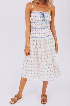 All dressed up and feeling fine, the Cry Baby Dress has got you covered. With adjustable straps and a fully lined design, this dress is as comfortable as it is stylish. The blue floral pattern and piping details add a touch of whimsy, while the front tie and pockets make it both practical and playful. Simply put, it's the perfect combination of fashion and function! Details Adjustable straps Fully lined Blue floral pattern Blue piping details Front tie detail Pockets Sizing Approximate measureme Blue Sundress With Adjustable Straps For Garden Party, Lined Spaghetti Strap Dress For Daytime, Daytime Spaghetti Strap Lined Dress, Light Blue Spring Dress With Adjustable Straps, Blue Tie Straps Dress For Garden Party, Blue Garden Party Dress With Tie Straps, Blue Dress With Tie Straps For Garden Party, Light Blue Lined Spaghetti Strap Dress, Cream Sundress With Spaghetti Straps For Spring