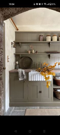 an old fashioned kitchen with green cabinets and white counter tops is seen in this image