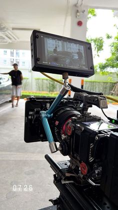 a video camera is attached to a tripod