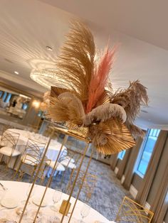 a fancy centerpiece in the middle of a dining room set up for an event