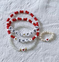 Show your school pride and complete your game day outfit with a custom red and white beaded bracelet for Sacred Heart University! Valentine's Day Jewelry With Colorful Beads, Valentine's Day Colorful Beads White Jewelry, Valentine's Day White Jewelry With Colorful Beads, Personalized Red Name Bracelet With Round Beads, Red Letter Beads For Friendship, Personalized White Heart Beaded Bracelets, Personalized White Heart-shaped Beaded Bracelets, Customized Red Beaded Bracelets With Round Beads, Red Beaded Name Bracelet