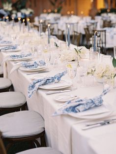 the table is set with white and blue linens