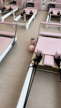 a room filled with lots of pink and white beds