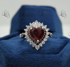 Stunning Lovable Red Heart Cut Diamond Ring, Baguette Prong Set Ring, Wedding Bridal Ring, Valentine Gift , Anniversary Gift Jewelry Main Stone Shape: Heart Main Stone Weight: 2.50CT Main Stone Colour: Red Main Stone Type: Cubic Zirconia Primary Stone Shape: Round & Baguette Primary Stone Colour: White, Red & Black Primary Stone Type: Cubic Zirconia Metal : Sterling Silver Metal Purity : 925 Please contact us for Different Metal Color & Purity. ✱ ETSY SHOP : https://www.etsy.com/in-en/shop/Creat Red Heart Ring With Center Stone For Wedding, Red Heart Shaped Wedding Rings, Red Diamond Heart Ring For Wedding, Heart-shaped Red Ruby Wedding Ring, Wedding Red Diamond Heart Ring, Heart-shaped Ruby Wedding Jewelry, Heart Shaped Red Ruby Ring For Wedding, Heart-shaped Ruby Jewelry For Wedding, Red Heart Cut Rings For Wedding